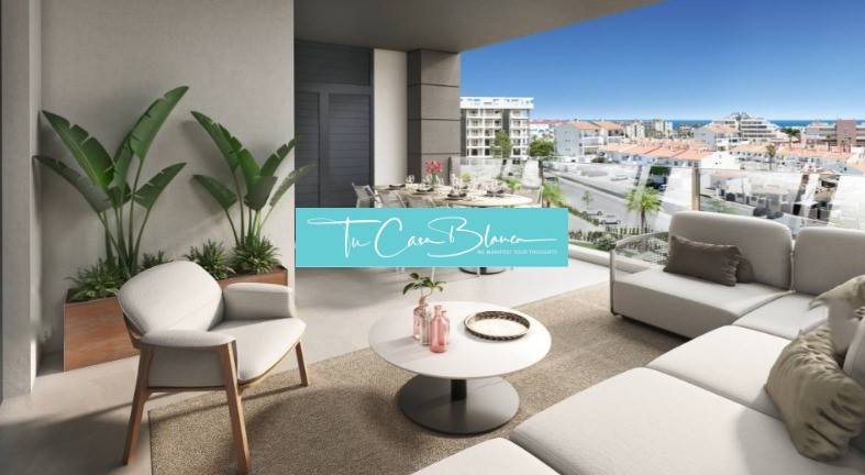 A balcony of a holiday apartment in Torrevieja with a view of the city and the sea.