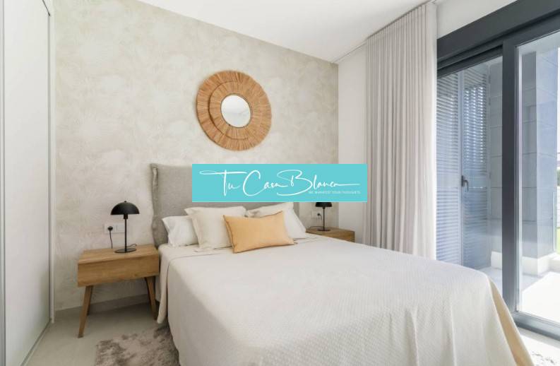 Bedroom in a holiday apartment, bed, nightstands, large window.