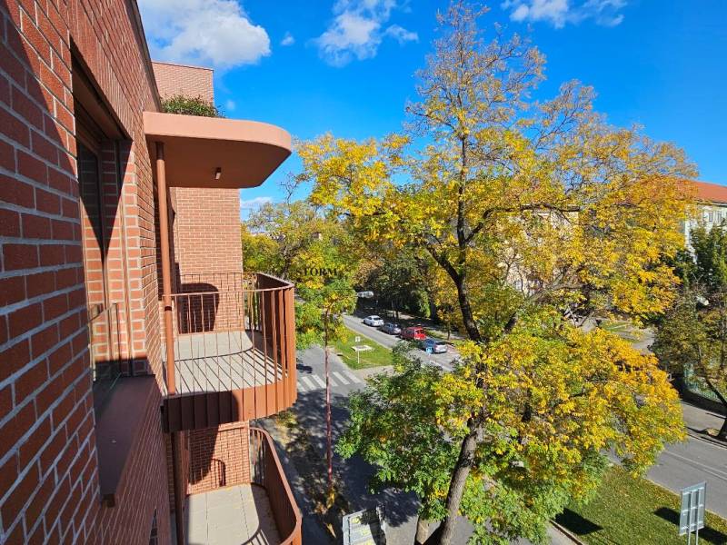 View from the balcony of a brick house onto the street in Bratislava - Ružinov, Košická.