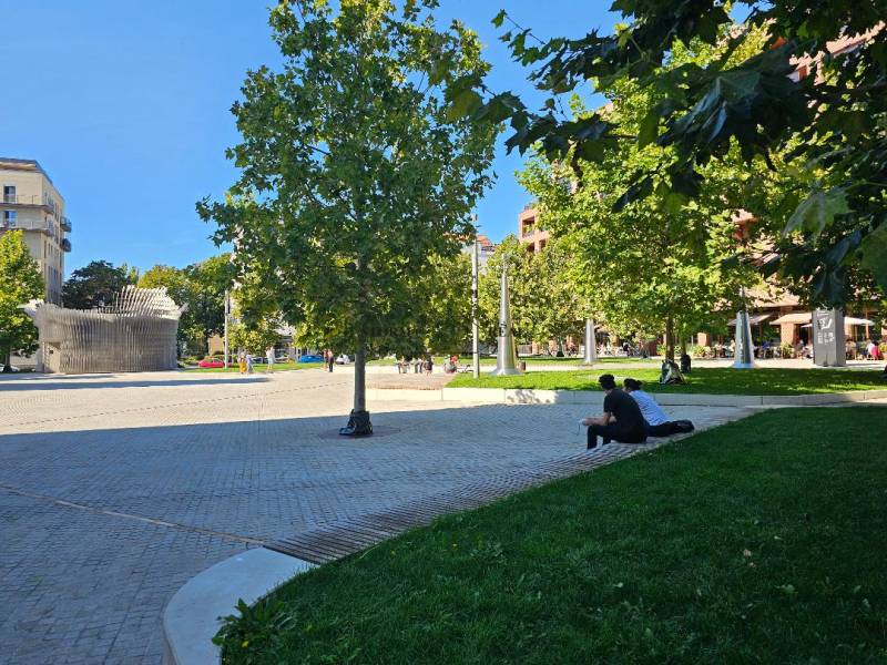 Park in Bratislava - Ružinov with people relaxing on benches on Košická Street.