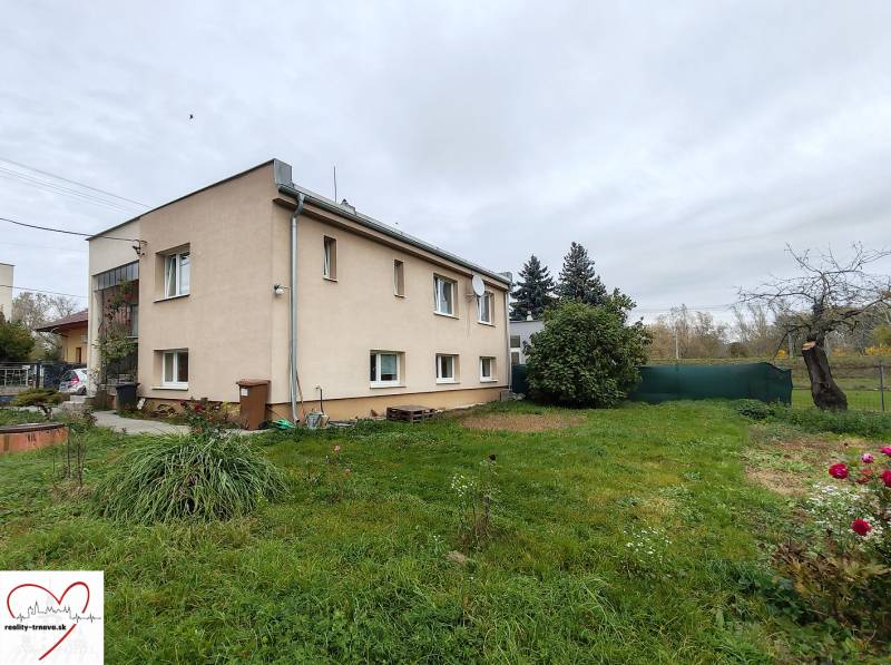 A family house on Topoľová Street in Sereď with a grassy garden and shrubs.