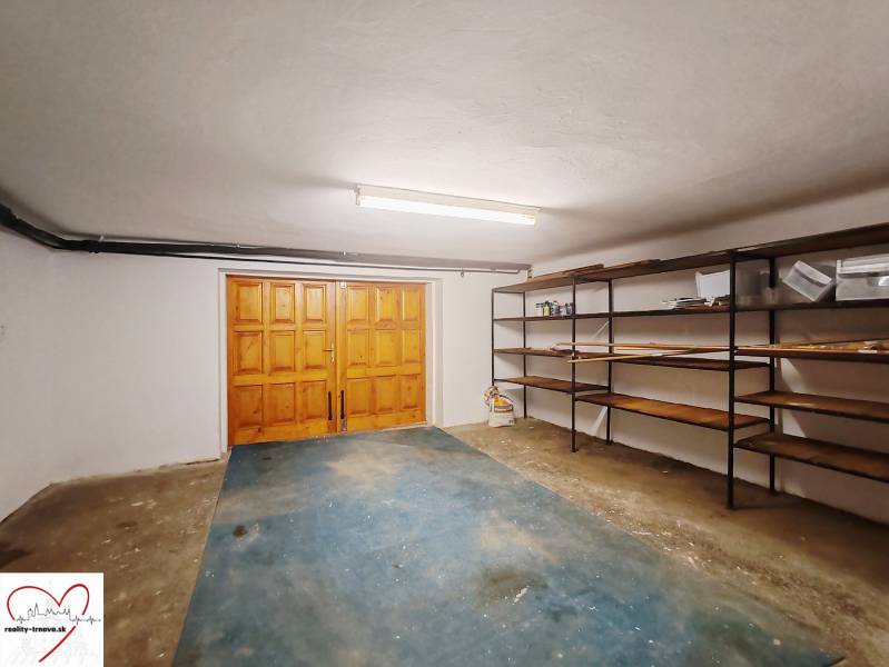 A garage in a family house with wooden doors and shelving units.
