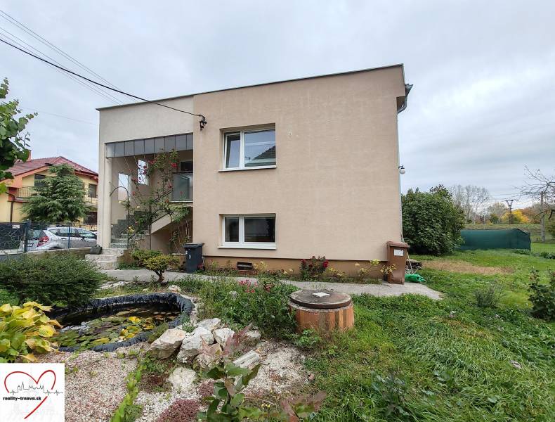 A family house on Topoľová Street in Sereď with a decorative garden and a pond.