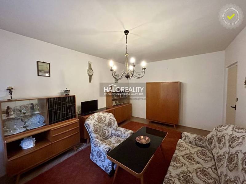 Living room with antique furniture and a chandelier in a 4-room apartment.