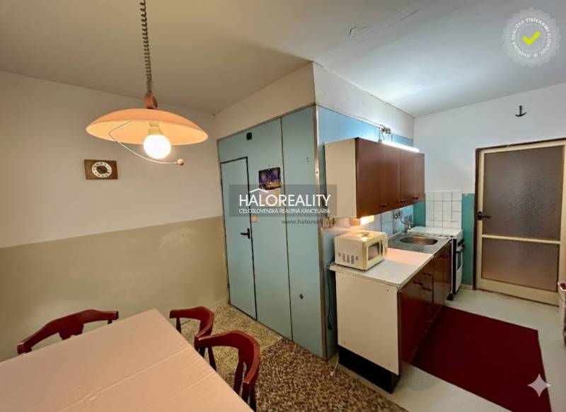 Kitchen in a 4-room apartment with a dining table and kitchen unit.