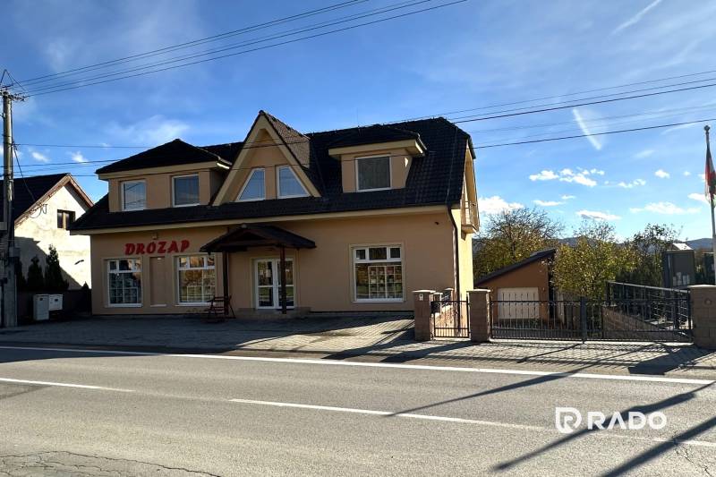 A family house in Bolešov with an attic, large windows, and a commercial space on the ground floor.