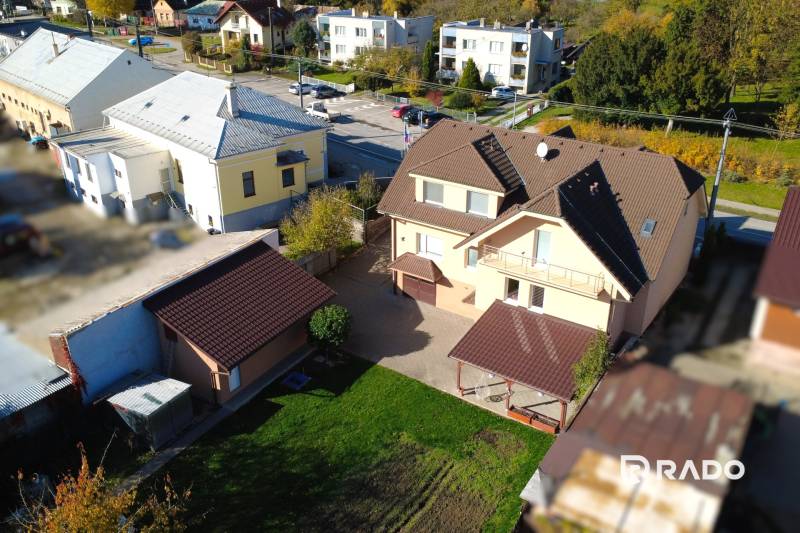 A family house in Bolešov with a balcony, garage, and landscaped yard.
