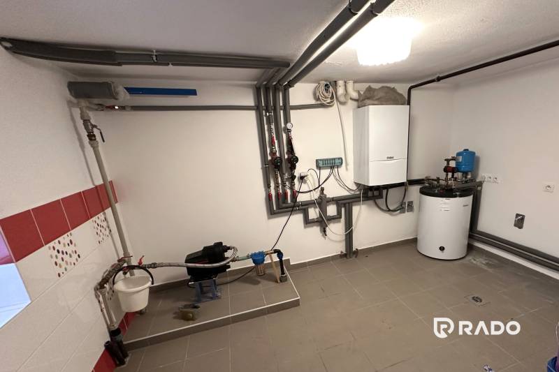 Technical room in a family house with a gas boiler and piping.