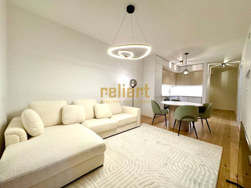 Living room in a two-room apartment with a wooden decor floor and light furniture.