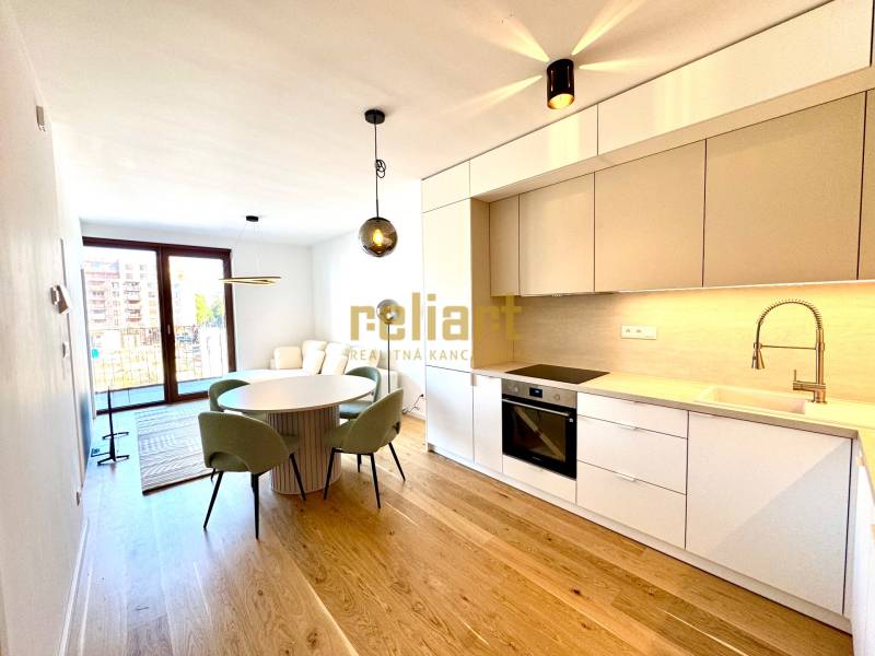 Kitchen unit, dining table, wooden decor flooring in a 2-room apartment.