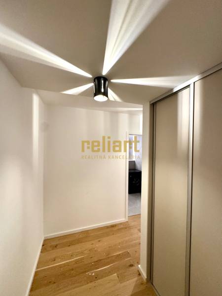 Hallway in a 2-room apartment with a wooden decor floor and a built-in wardrobe.