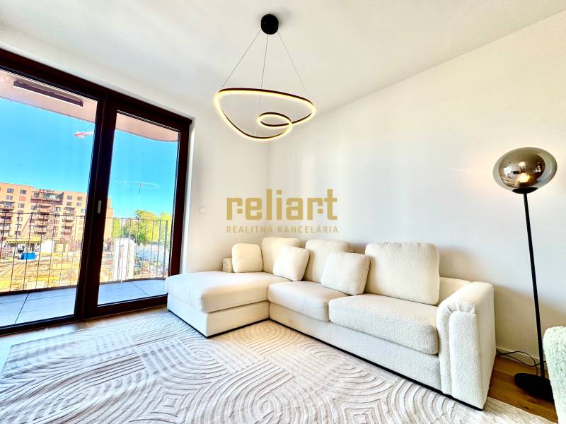 Living room with a white couch, floor lamp, and wood-patterned flooring.