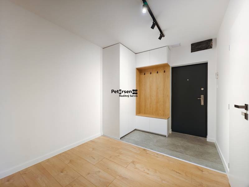 Entrance hallway with wood-patterned flooring and built-in furniture in a 2-room apartment.