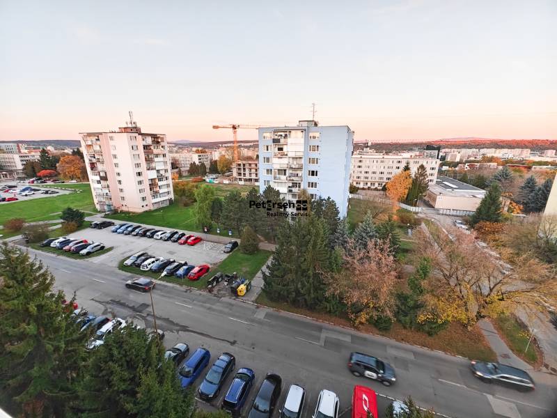 View from Považská Street in Košice - Západ district, panel buildings and greenery.