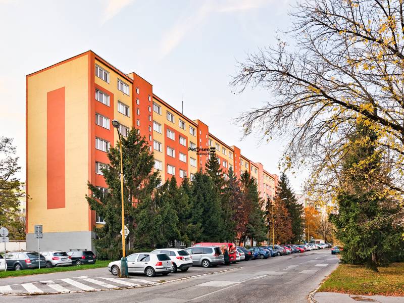 Považská Street, Košice - Západ district, near a residential building with cars and trees.