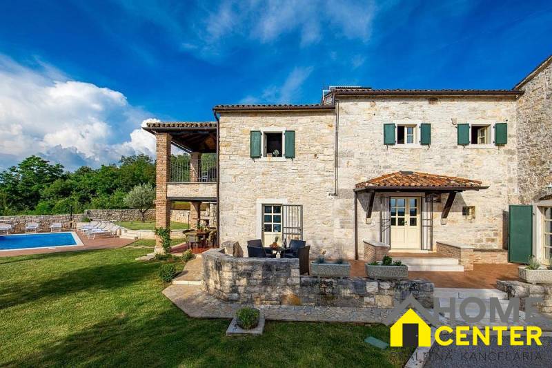Stone villa in Bale with a pool and terrace surrounded by greenery.