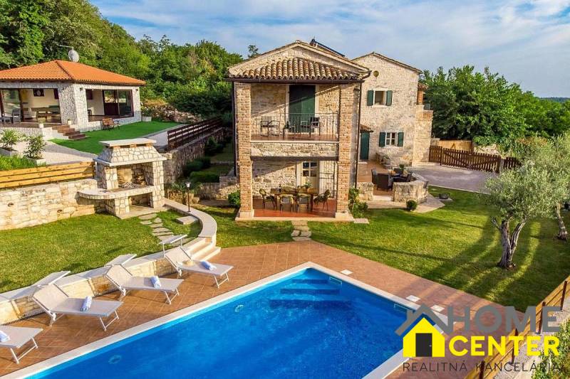 Villa in Bale with a garden, swimming pool, sun loungers, and a stone fireplace.