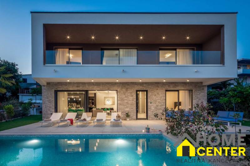 A villa in Bale with a pool and terrace, surrounded by greenery and relaxation areas.