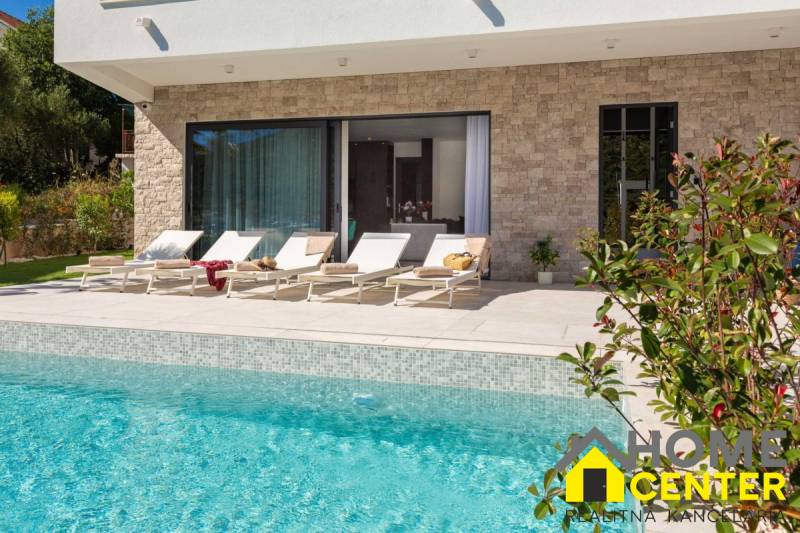 The exterior of the villa in Bale with a pool and loungers on the terrace.