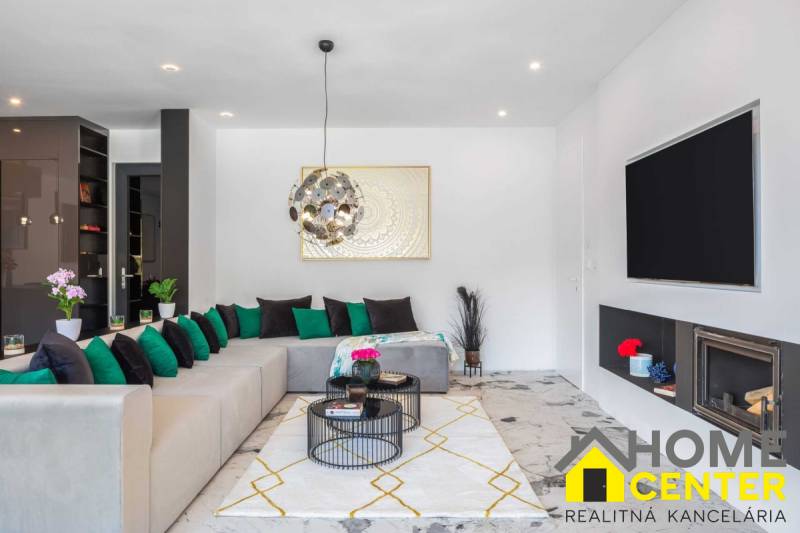 Living room with a comfortable sofa, fireplace, and decorations in the Villa.