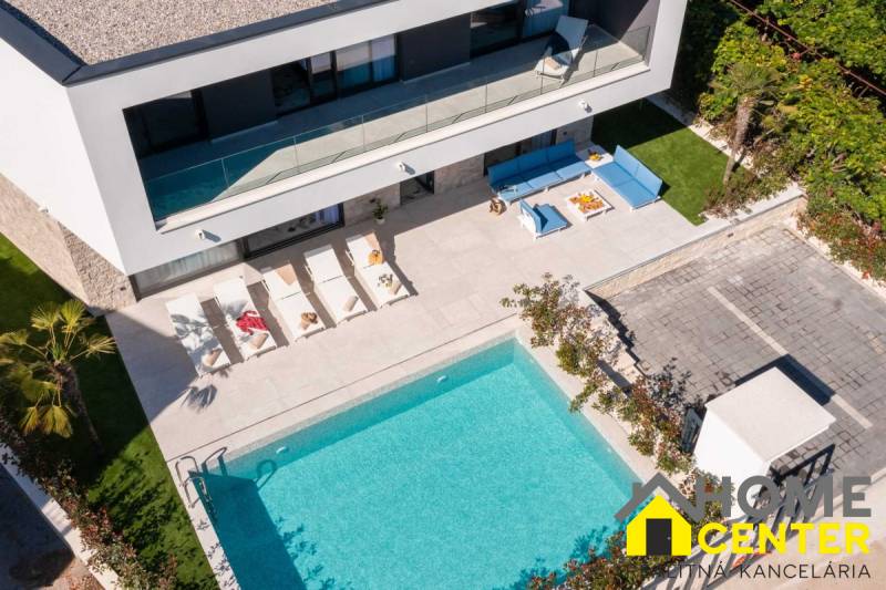 A villa in Bale with a pool, sun loungers, and comfortable outdoor seating.