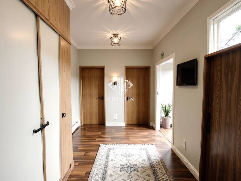 A hallway in a 3-room apartment with a wooden decor floor and light-colored walls.