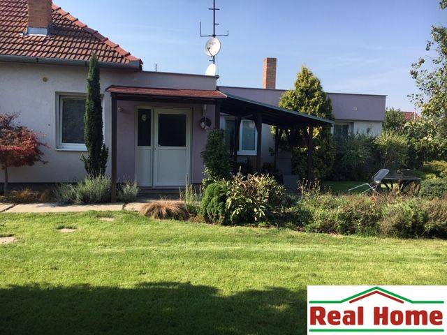A family house in Čierna Voda with a well-maintained garden and a covered terrace.