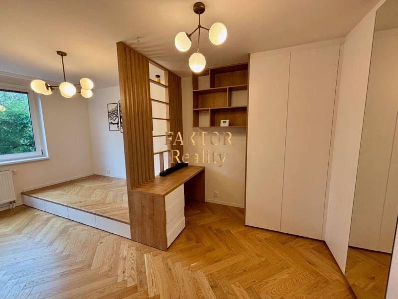 Interior of a 2-room apartment with a wooden decor floor and minimalist lighting fixtures.