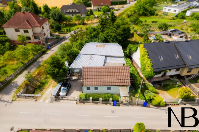 A family house on Záblatská Street in Trenčín, surrounded by greenery and other houses.