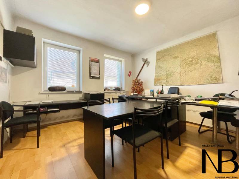 Office in a family house with a map on the wall and furniture for work and meetings.