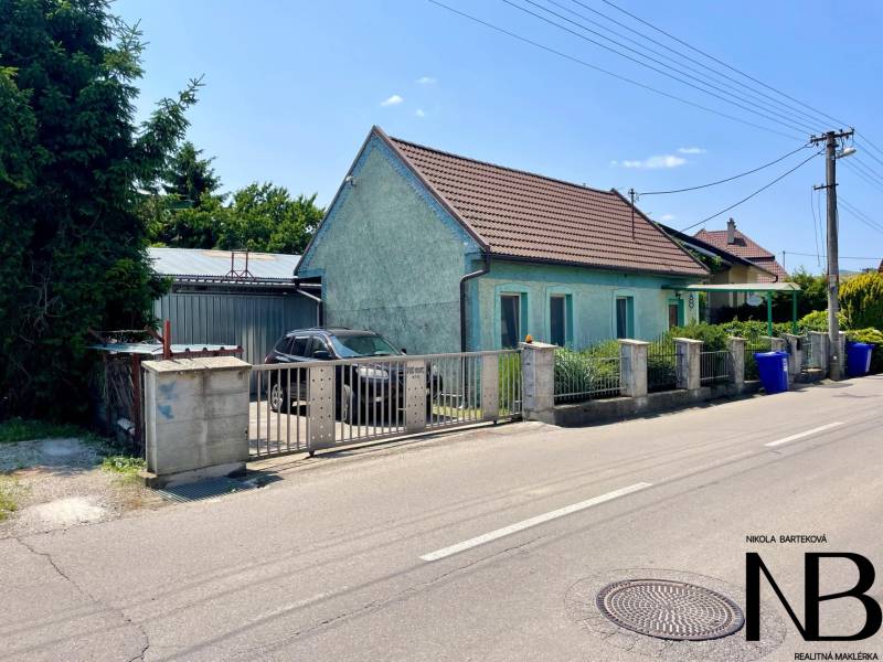 A family house on Záblatská Street in Trenčín with a car and a garage.