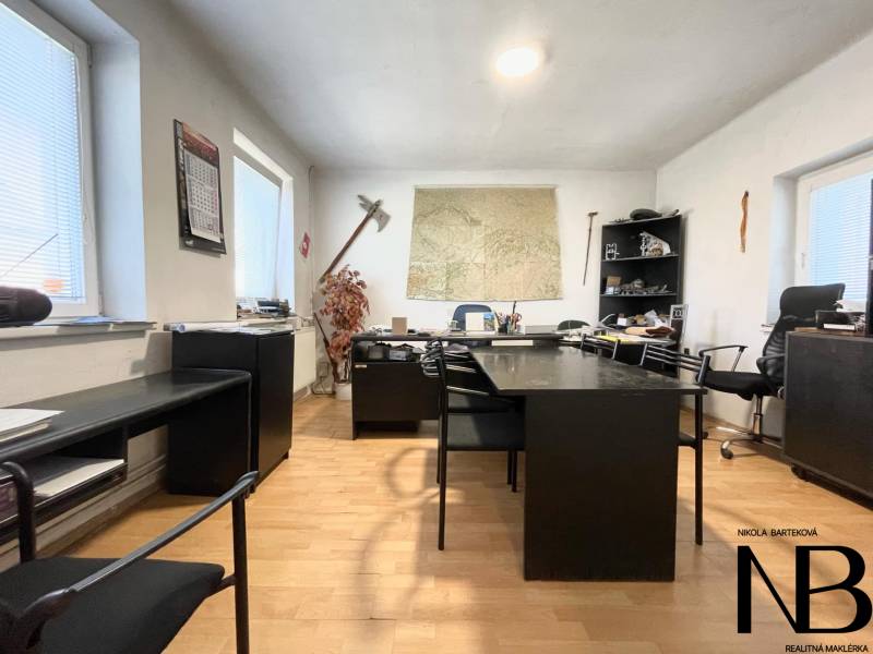 Office in a family house with dark furniture and a map on the wall.