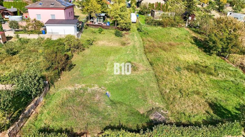 Plots - housing in Nitra with a landscaped garden and surrounding houses.