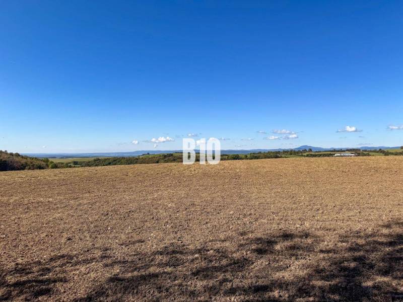 View of the fields behind Lackov, with hills on the horizon in the background.