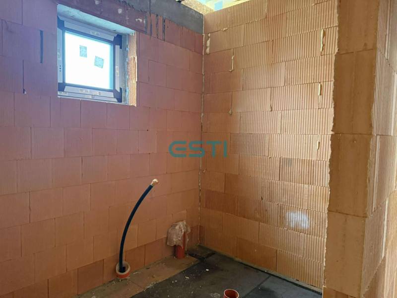 A construction room in a family house with brick walls and installation.