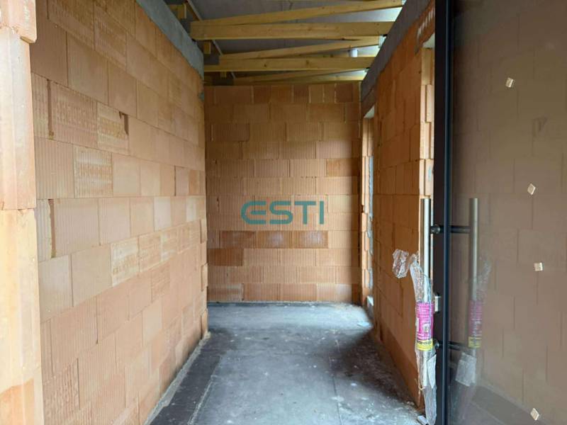 A building in a family house with brick walls and a concrete floor.