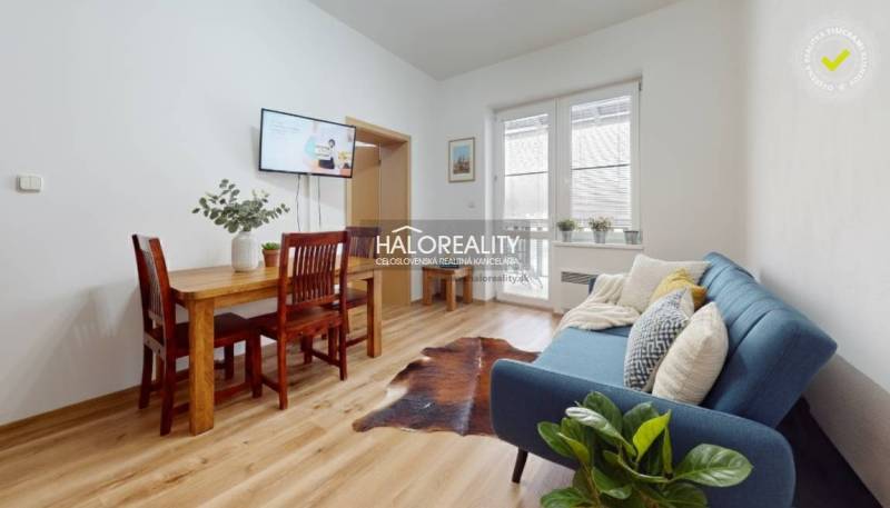 A kitchen unit with a marble decor and appliances in a 3-room apartment.
