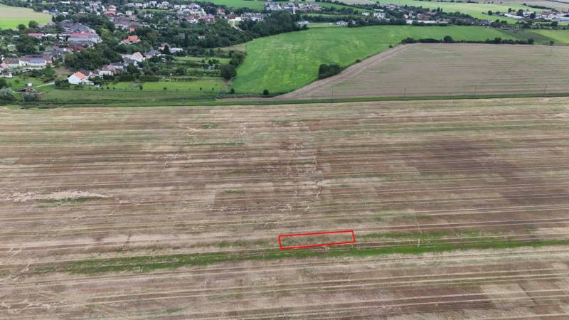 Agricultural and forest land near Nová Ves nad Váhom with a view of the village.