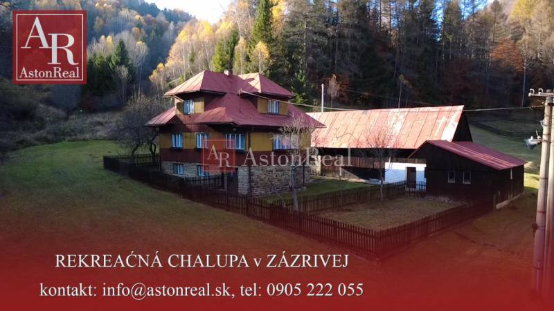 A family house in Zázrivá surrounded by forests, with stone and wooden construction.