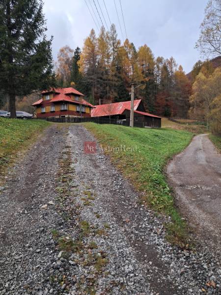 An autumn family house with a sloped roof in Zázrivá, surrounded by forests.