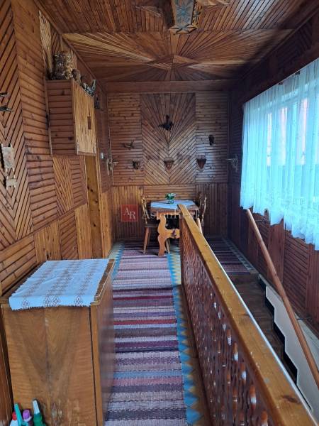 Interior of a family house with a wooden decor floor and traditional wall decorations.