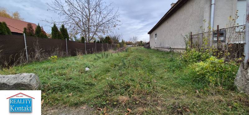 A plot of land in Tvrdošovce suitable for living with a grassy surface and fencing.