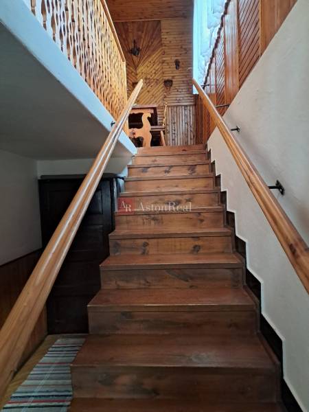 Interior of a family house with wooden stairs and paneling to the attic space.