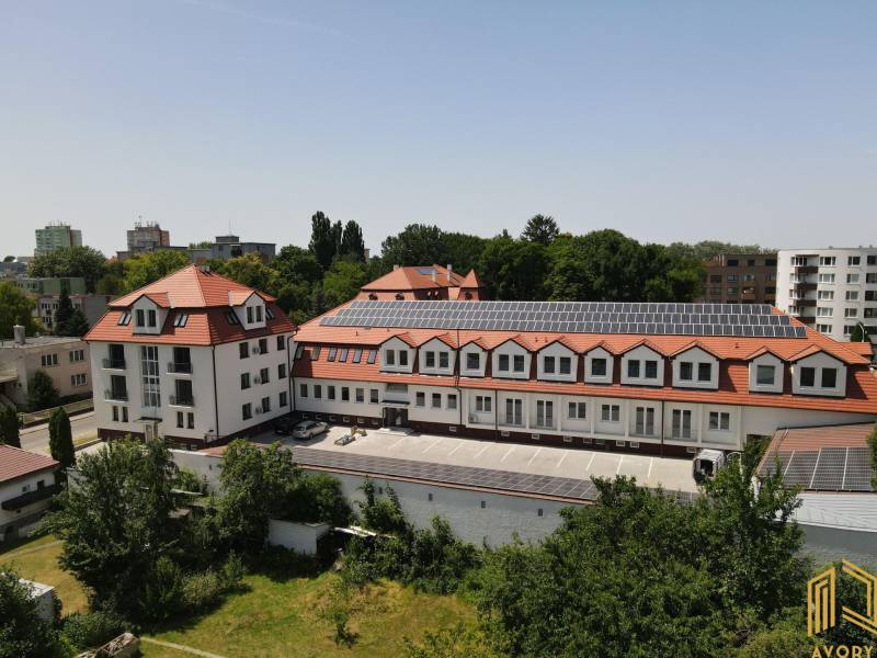 The building on Sadová Street in Senica with a red roof and solar panels.