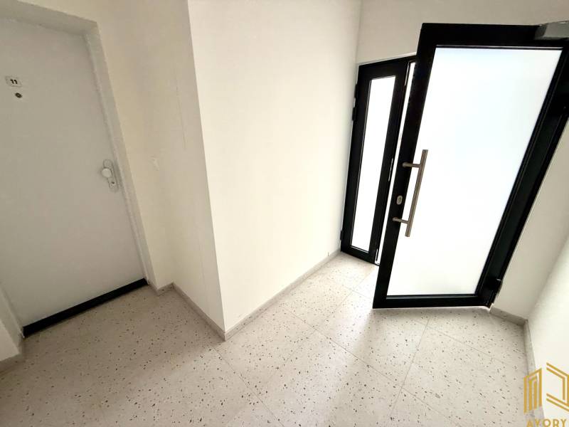 Entrance hallway in a 2-room apartment with glass doors.