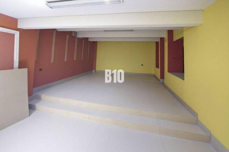 Commercial spaces with colorful walls and stairs, floor with a smooth surface.