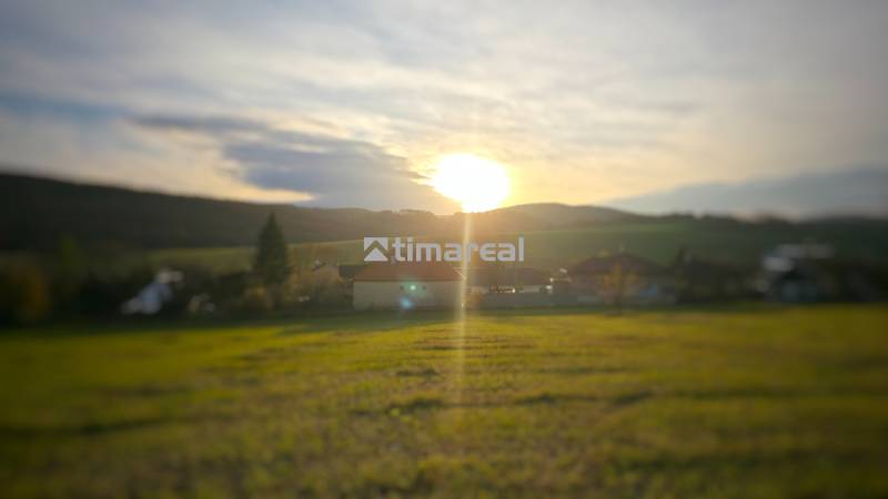 Sunset over family houses in Dobrá Voda, surrounded by natural scenery.