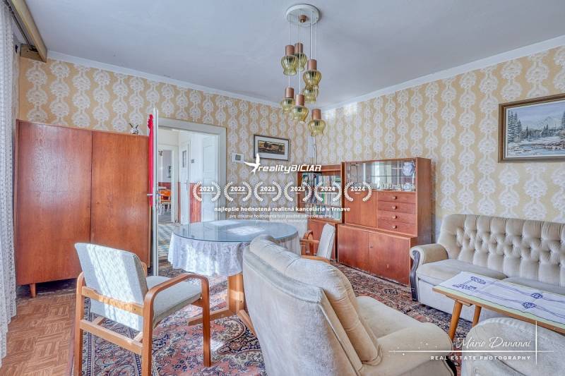 Living room in a family house with retro furniture and a wooden decor floor.