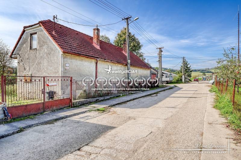 A family house on Dobrá Voda Street in Dobrá Voda, surrounded by greenery and a blue sky.