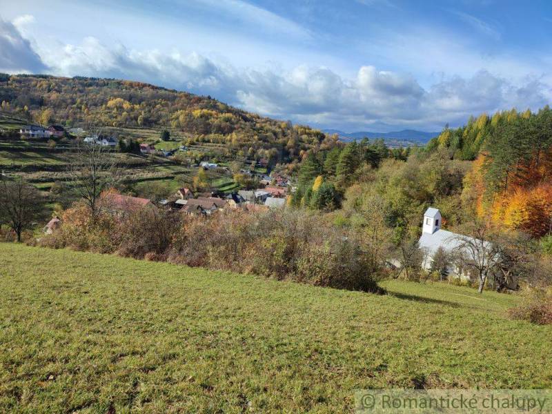 Autumn in the gardens of Hlboké nad Váhom with a church and colorful forests.